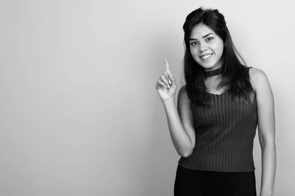 Young beautiful Indian woman against gray background — Stock Photo, Image