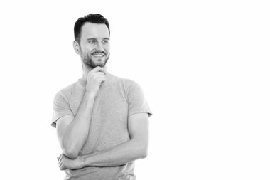 Black and white studio portrait of handsome young man with beard