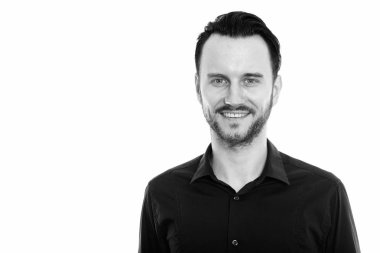 Black and white studio portrait of handsome young man with beard