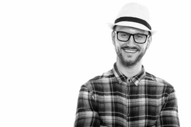 Black and white studio portrait of handsome young man with beard