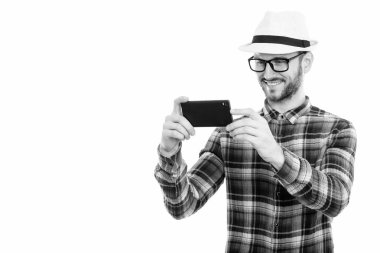 Black and white studio portrait of handsome young man with beard