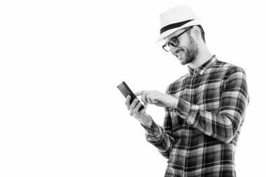 Black and white studio portrait of handsome young man with beard