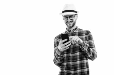 Black and white studio portrait of handsome young man with beard