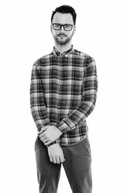 Black and white studio portrait of handsome young man with beard