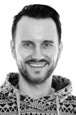 Black and white studio portrait of handsome young man with beard