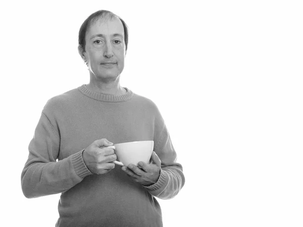 Studio shot of mature man holding coffee cup — Stock Photo, Image