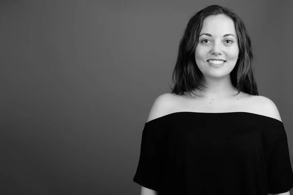 Portrait of young happy woman smiling shot in black and white