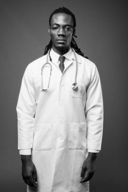 Kahverengi zemin karşı gözlük takan genç Afrika yakışıklı Doktor stüdyo çekim