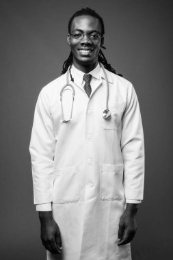 Kahverengi zemin karşı gözlük takan genç Afrika yakışıklı Doktor stüdyo çekim