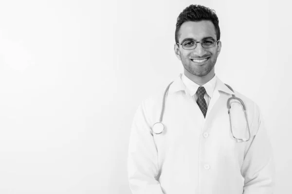 Young handsome Indian man doctor against white background — Stock Photo, Image