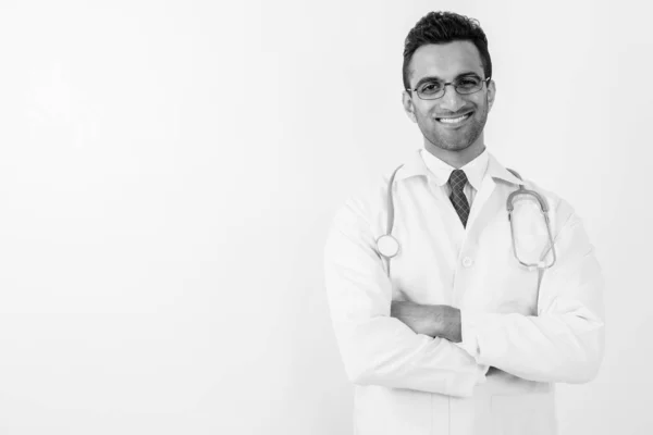 Young handsome Indian man doctor against white background — Stock Photo, Image