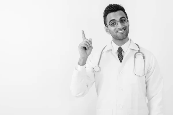 Young handsome Indian man doctor against white background — Stock Photo, Image