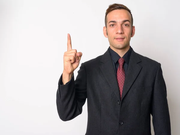Young Persian businessman in suit pointing up — Stock Photo, Image