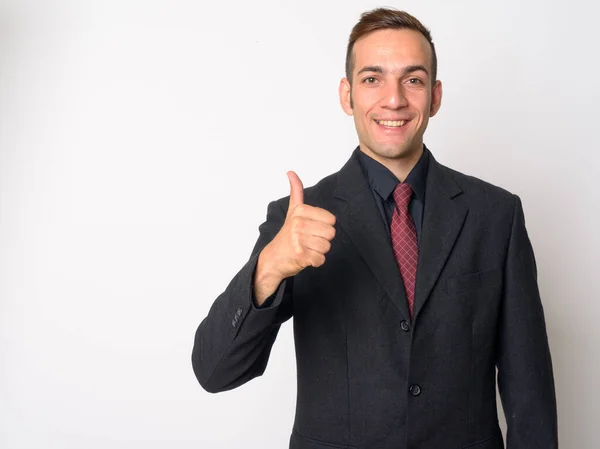 Happy young Persian businessman in suit giving thumbs up — Stock Photo, Image