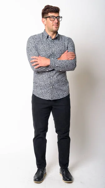 Full body shot of young Persian businessman wearing eyeglasses and thinking with arms crossed — Stock Photo, Image