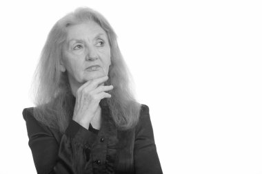 Siyah beyaz çekilen yaşlı bir kadının stüdyo portresi.