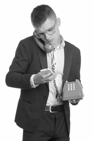 Stúdió lövés fiatal üzletember beszél a régi telefon használata közben mobiltelefon — Stock Fotó