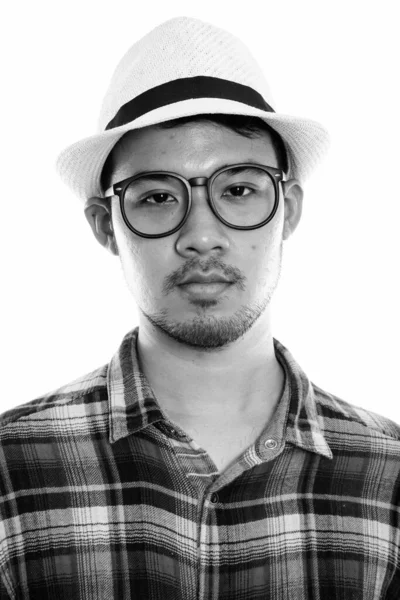 Face of young Asian man wearing eyeglasses and hat — Stock Photo, Image
