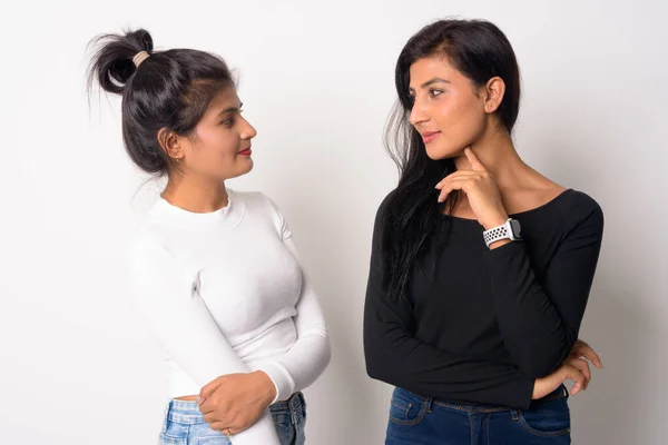 Two young beautiful Persian women looking at each other