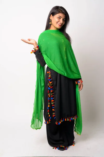 Full body shot of happy young Persian woman smiling in traditional clothing — Stock Photo, Image