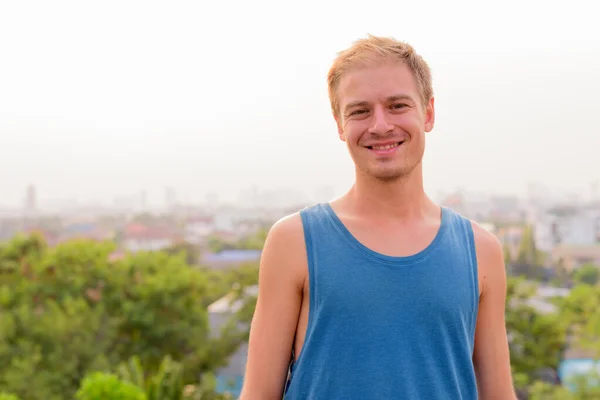 Junger schöner Mann mit blonden Haaren entspannt sich im Freien — Stockfoto