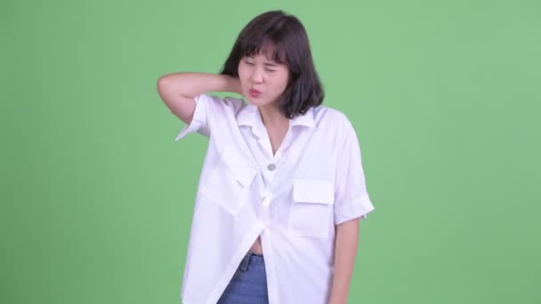 Stresszes ázsiai üzletasszony, akinek nyakfájás — Stock videók