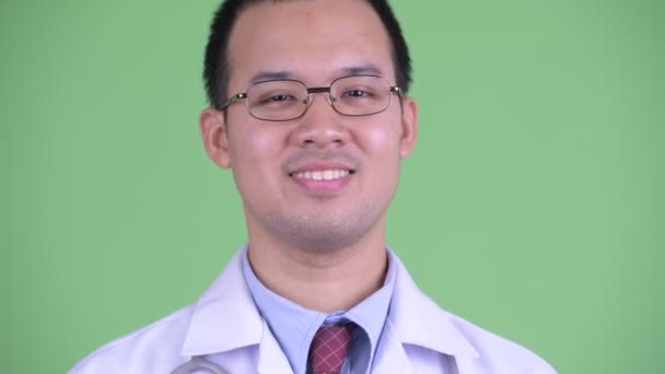 Face of happy Asian man doctor nodding head yes — Stock Video