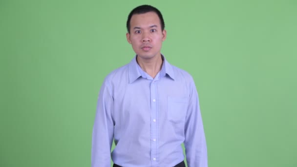 Studio skott av glad asiatisk affärsman får goda nyheter — Stockvideo