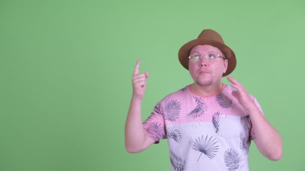 Šťastný nadváha vousatý turista ukazuje nahoru a vypadá vzrušeně — Stock video