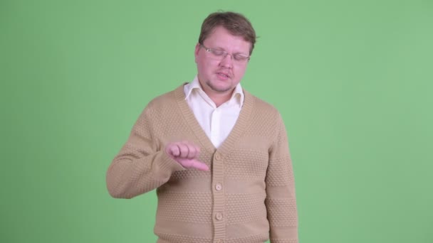 Triste sobrepeso barbudo homem dando polegares para baixo — Vídeo de Stock