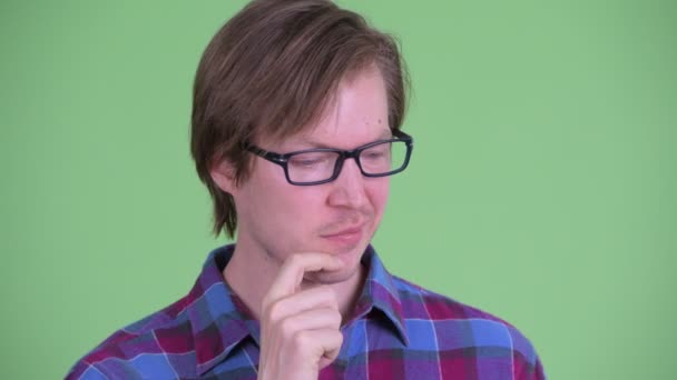 Face of stressed young handsome hipster man thinking — Stock Video