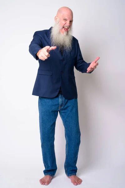 Full body shot of happy mature bearded bald businessman pointing at camera — Stock Photo, Image