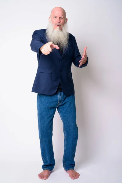 Full body shot of mature bearded bald businessman pointing at camera — Stock Photo, Image