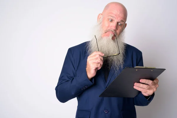 Mature bearded bald businessman reading on clipboard and getting good news — Stock Photo, Image