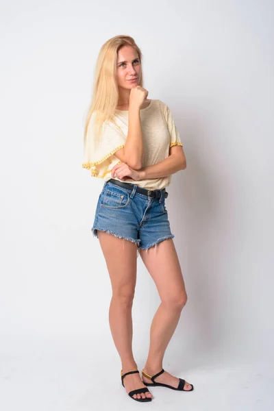 Full body shot of young beautiful blonde woman thinking — Stock Photo, Image