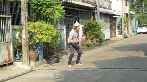 Scared young man with tin foil hat panicking outdoors as conspiracy theory concept — Stock Video