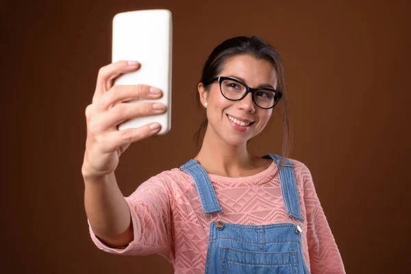 Portrait of beautiful multi ethnic nerd woman using phone — Stock Photo, Image