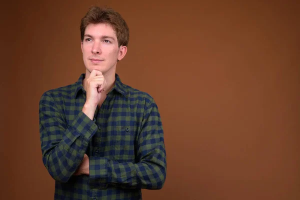 Portrait of young handsome hipster man in green checkered shirt — ストック写真