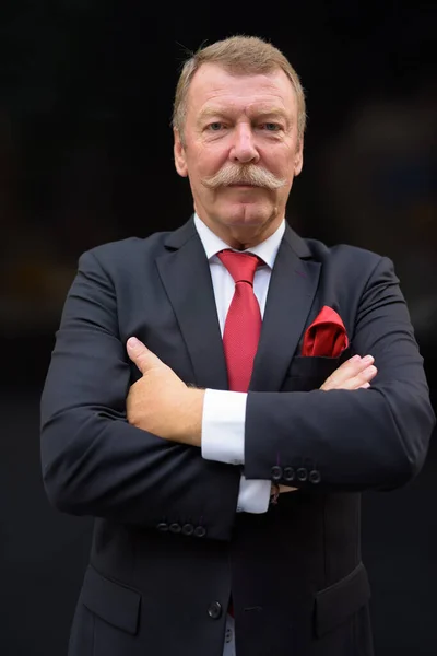 Handsome senior businessman with mustache exploring the city — Stock Photo, Image