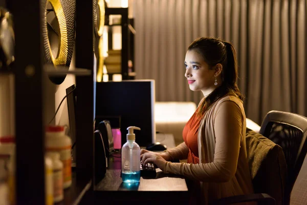Young beautiful Indian woman working from home late at night during quarantine for corona virus covid-19 pandemic