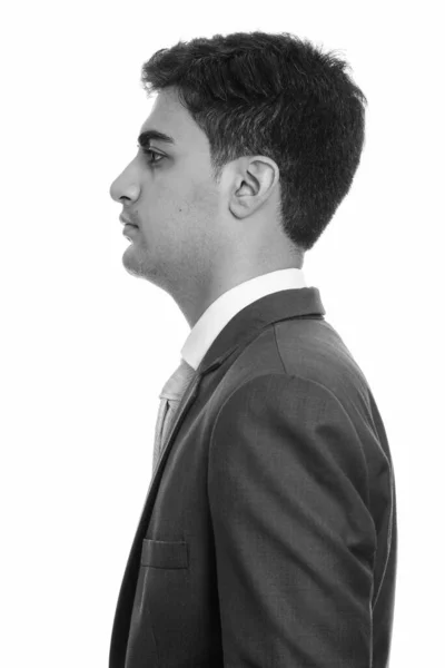 黒と白の白の背景を背景に訴訟で若いハンサムなペルシャのビジネスマンのスタジオショット — ストック写真