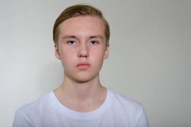 Portrait of young handsome blond teenage boy