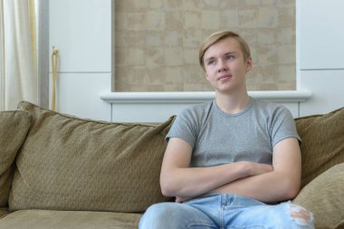 Portrait of young handsome blond teenage boy