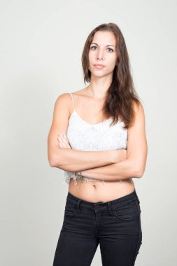Studio shot of young beautiful woman with brown hair against white background
