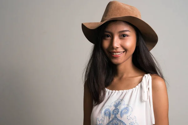 Happy young beautiful Asian teenage girl as tourist smiling — Stock Photo, Image