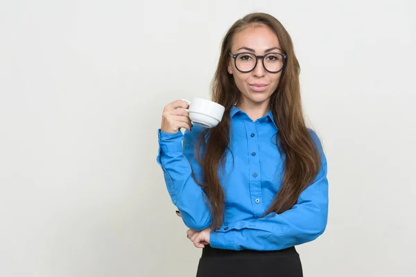 Portrait of young businesswoman with eyeglasses holding coffee cup — Stock Photo, Image