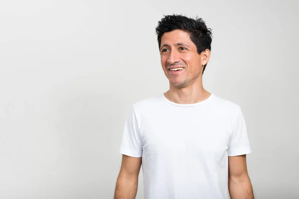 Portrait of happy Hispanic man thinking and looking up — Stock Photo, Image