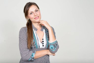 Studio shot of young beautiful woman with brown hair  