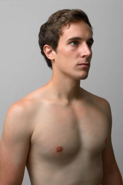 Studio shot of young handsome man shirtless against white background