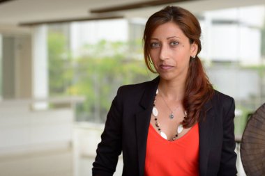 Portrait of Hispanic businesswoman inside the office building